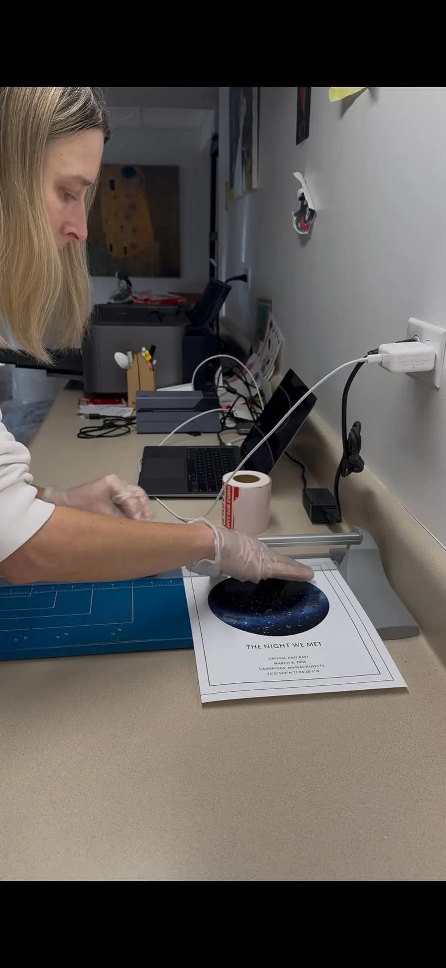 Olga carefully preparing a star map poster for shipping